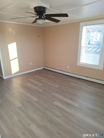 wooden floor in an empty room with a window