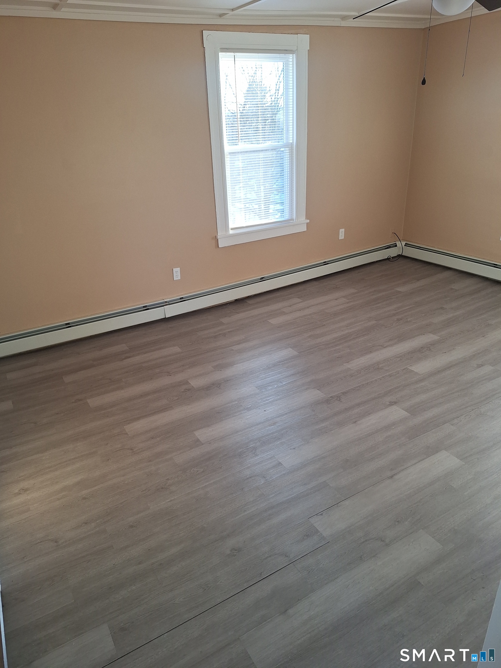 23 1/2 North Spring Street, Unit 3 Ansonia, CT 06401 - Photo 4 of 12 an empty room with wooden floor and windows