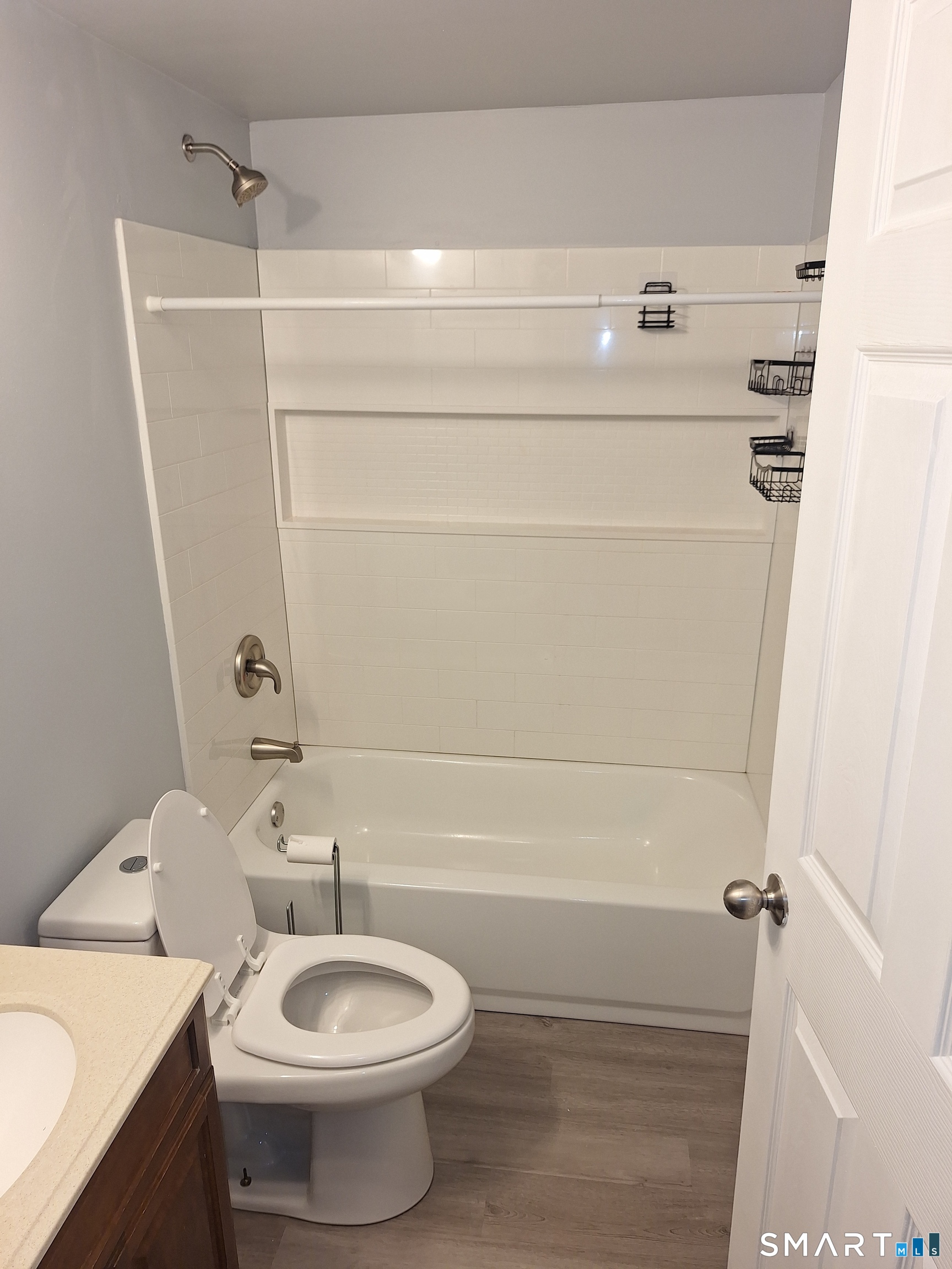 23 1/2 North Spring Street, Unit 3 Ansonia, CT 06401 - Photo 7 of 12 a bathroom with a sink a toilet and bathtub