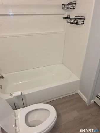 a bathroom with a toilet and a bathtub