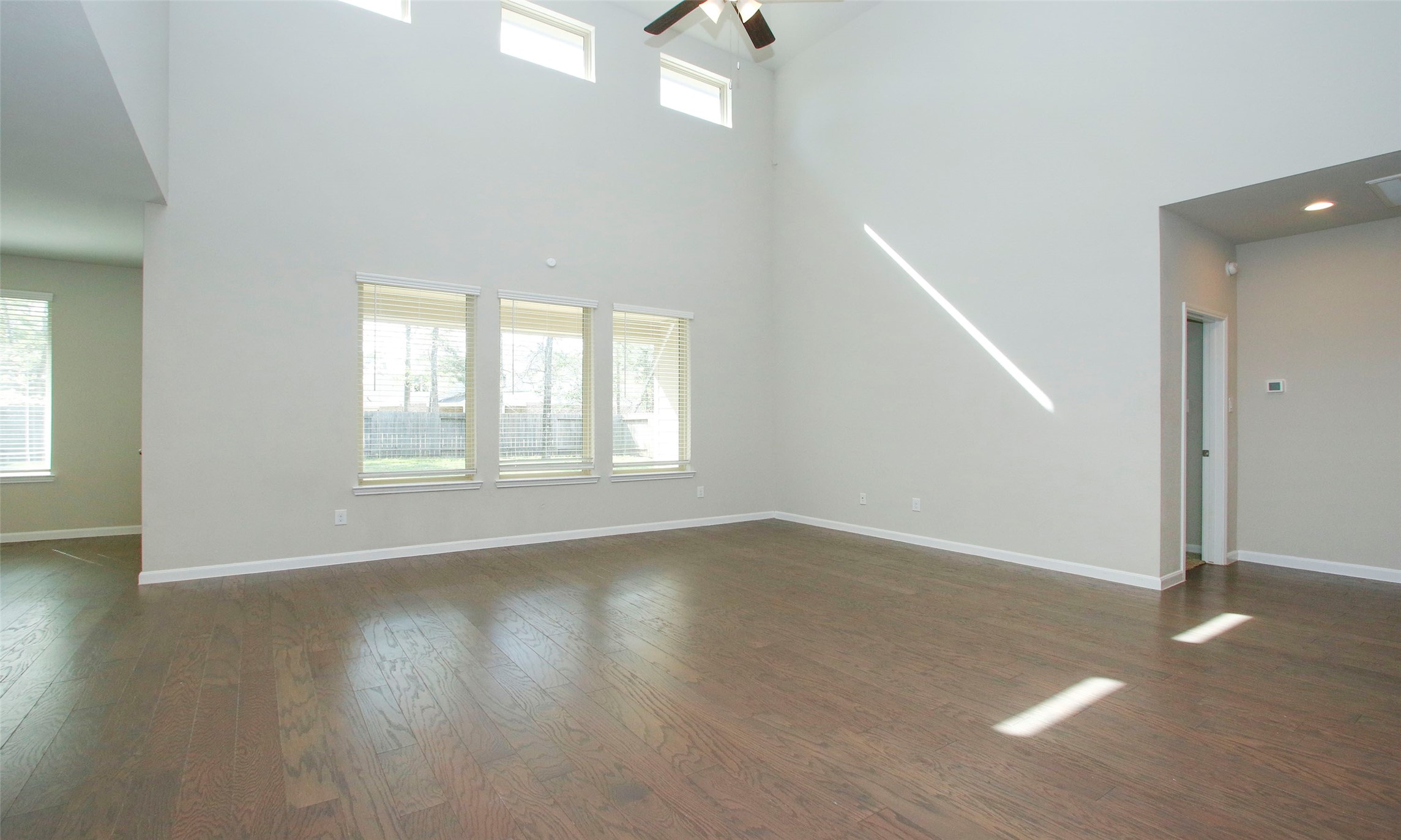 14120 Sand Ridge Court Conroe, TX 77384 - Photo 11 of 43 an empty room with wooden floor and windows