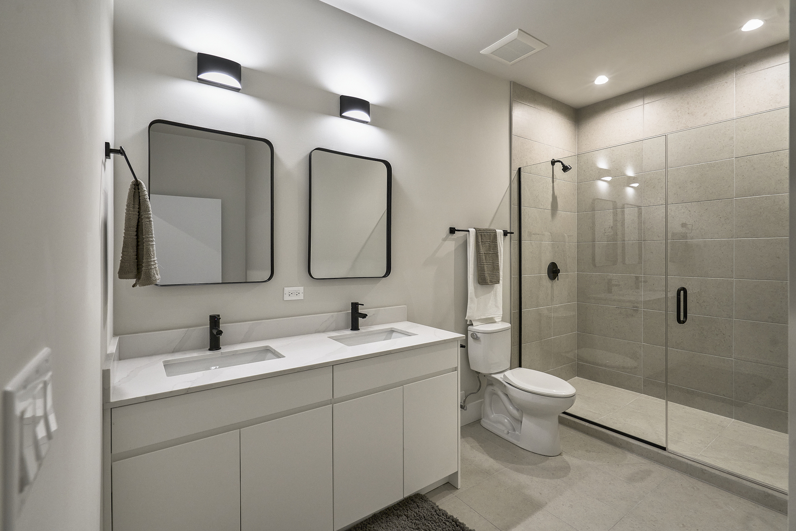 451 East Pershing Road, Unit 503 Chicago, IL 60653 - Photo 25 of 30 a spacious bathroom with a double vanity sink mirror double and shower
