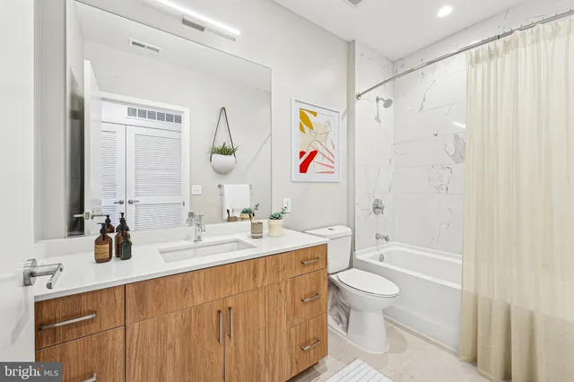 a kitchen with stainless steel appliances granite countertop table chairs and cabinets