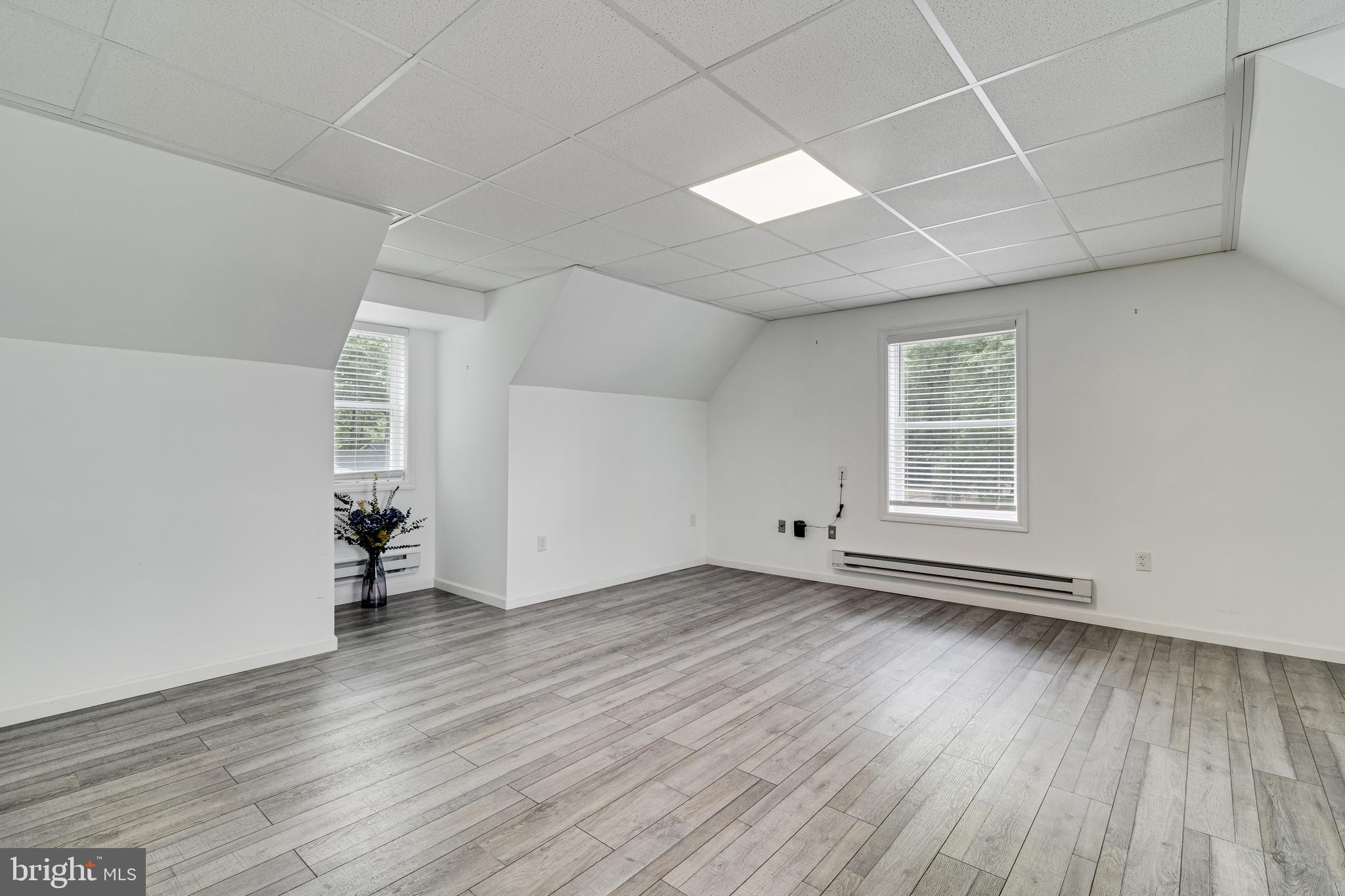 12015 Woodbury Road Nanjemoy, MD 20662 - Photo 10 of 53 an empty room with wooden floor and windows