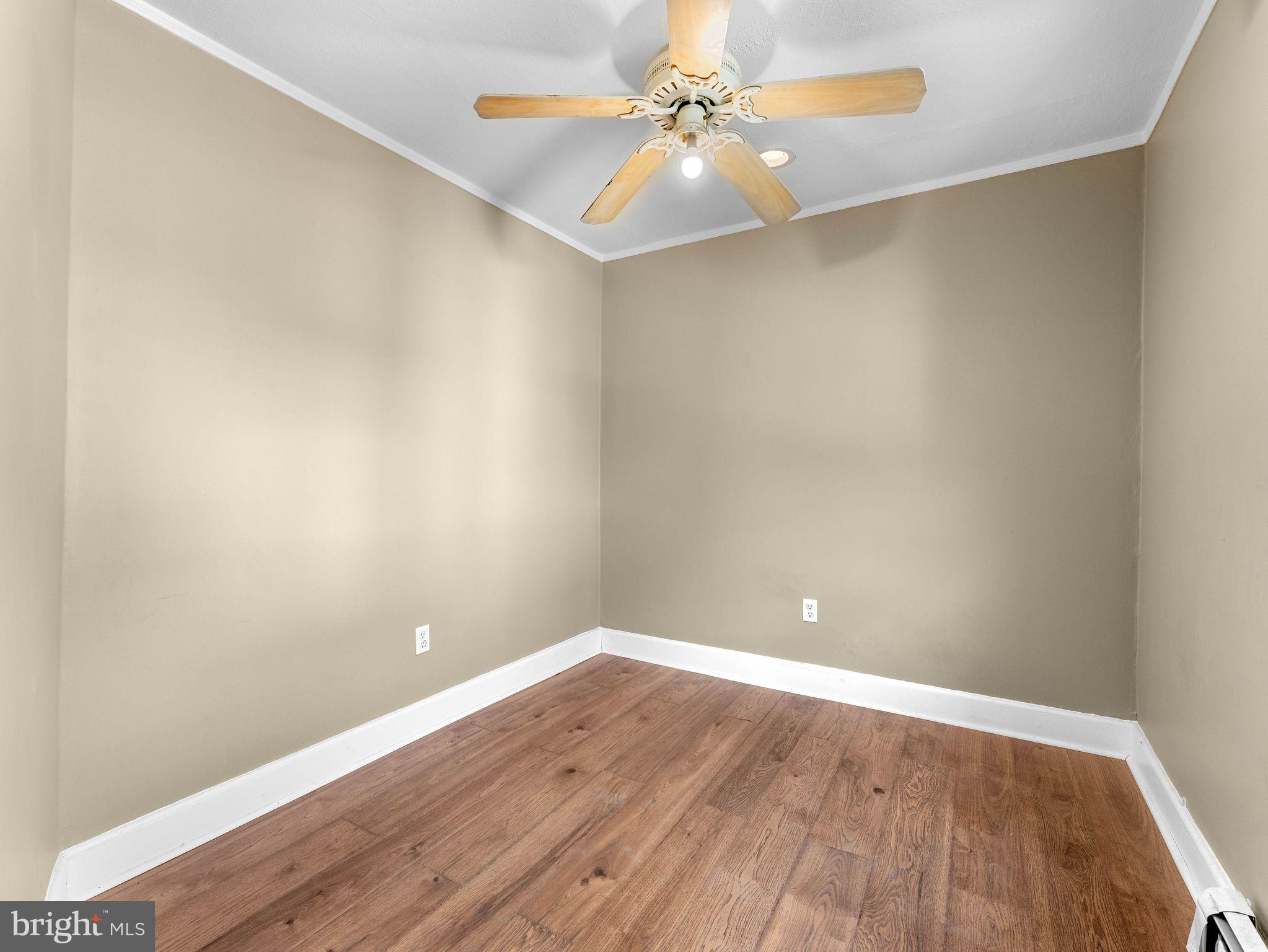 860 Pennsylvania Avenue Delanco, NJ 08075 - Photo 16 of 28 an empty room with wooden floor and fan