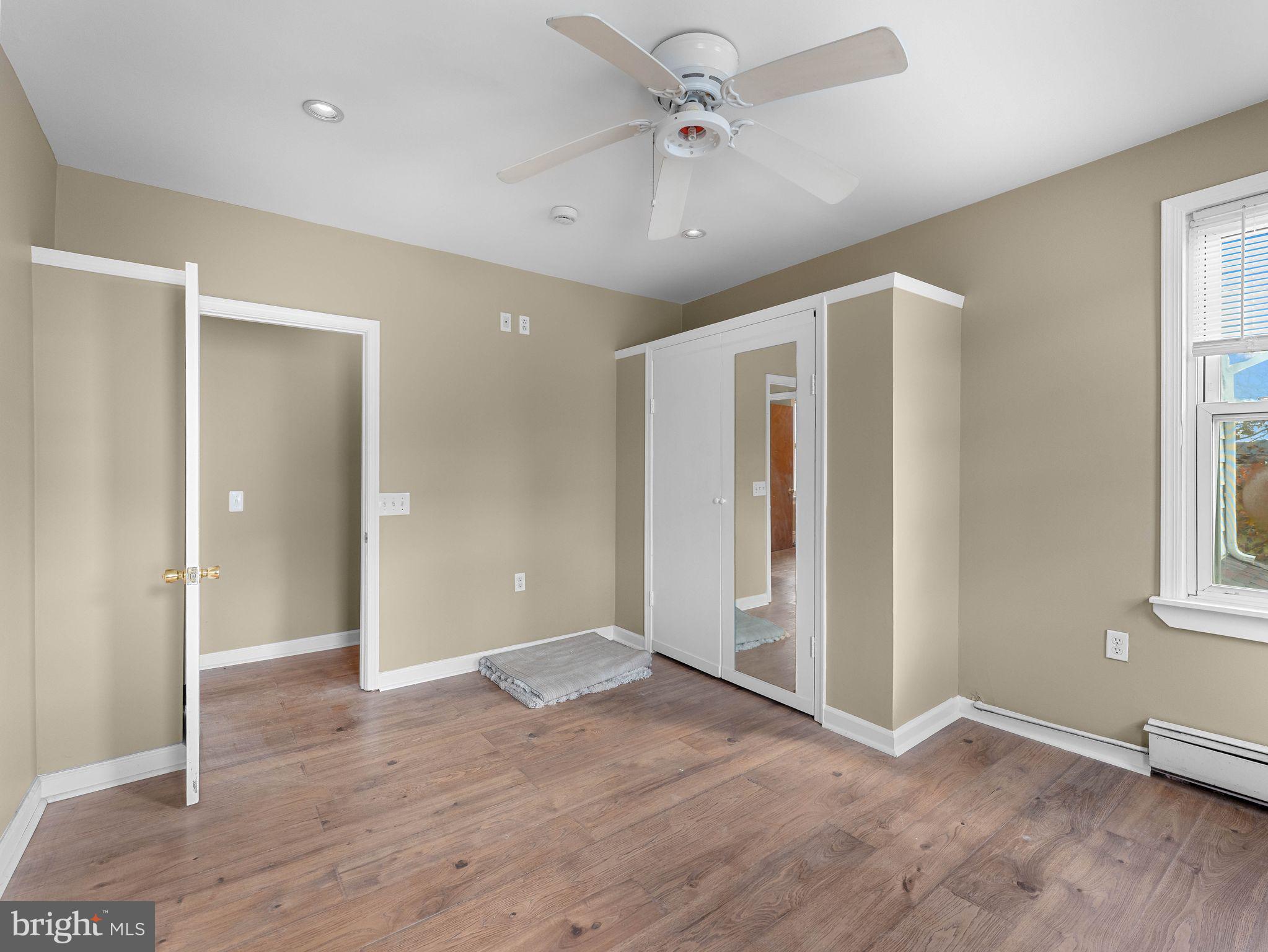 860 Pennsylvania Avenue Delanco, NJ 08075 - Photo 19 of 28 a view of an empty room with window and wooden floor
