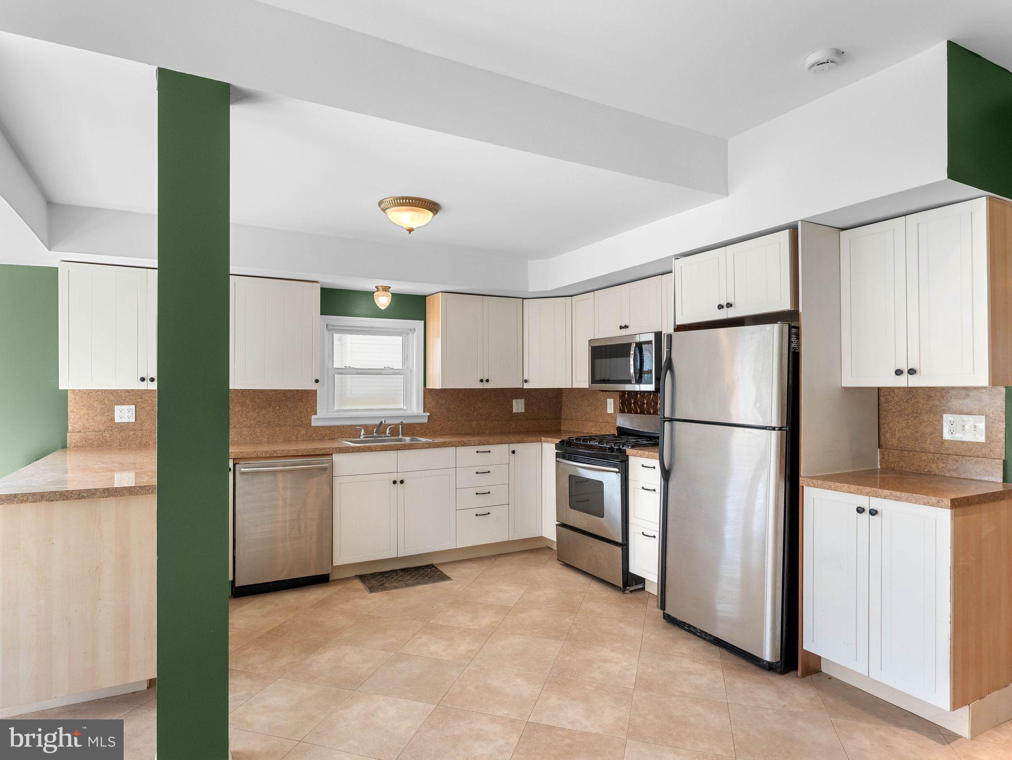 860 Pennsylvania Avenue Delanco, NJ 08075 - Photo 5 of 28 a kitchen with a refrigerator sink and stove