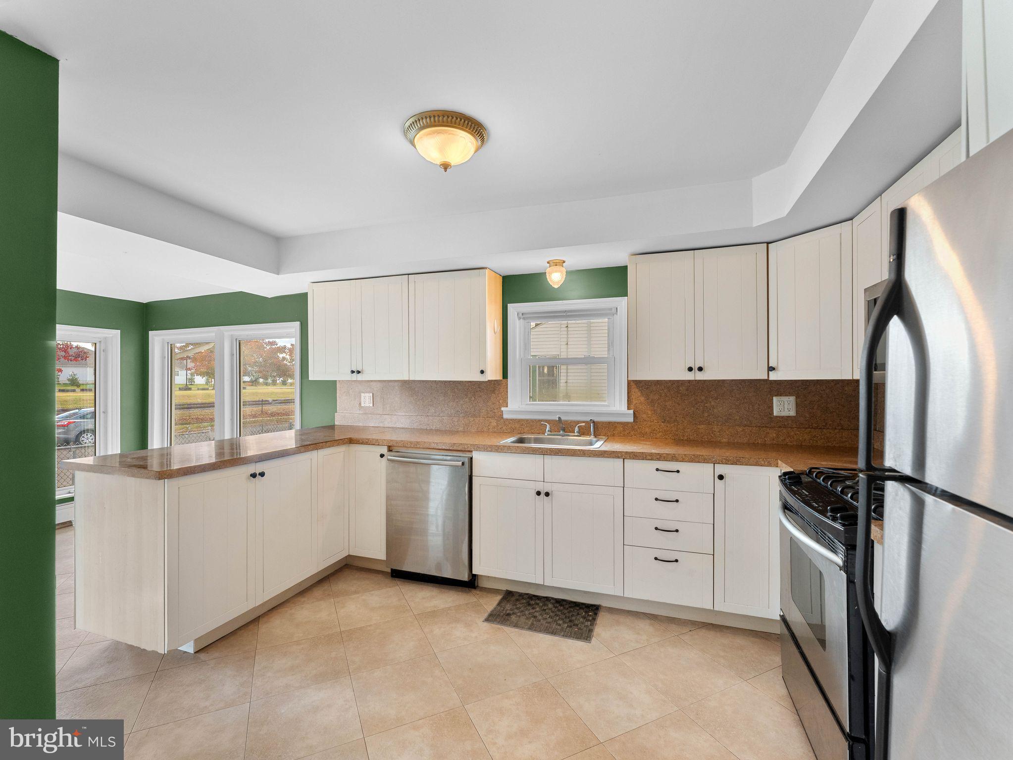 860 Pennsylvania Avenue Delanco, NJ 08075 - Photo 6 of 28 a kitchen with granite countertop a sink stainless steel appliances and cabinets