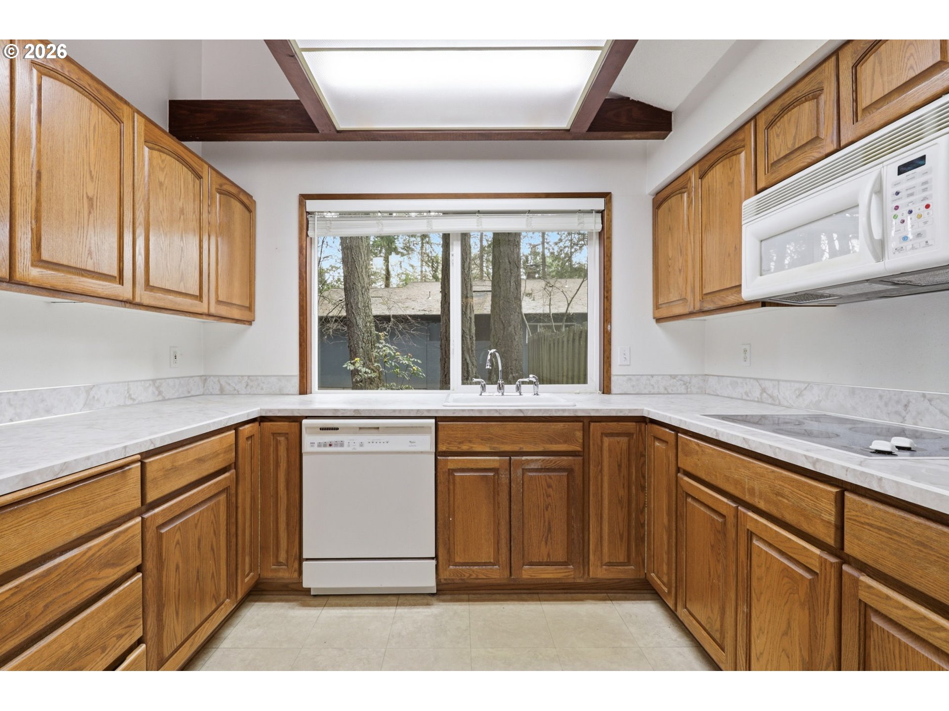 7250 Southwest 28th Court Beaverton, OR 97008 - Photo 17 of 45 a kitchen with granite countertop a sink stainless steel appliances and cabinets
