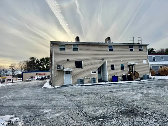 a view of a car park in front of house