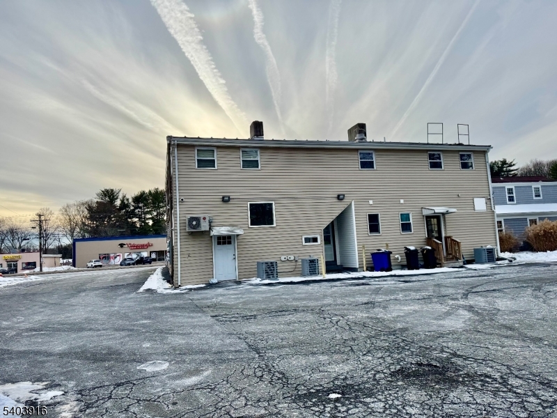 a view of a car park in front of house
