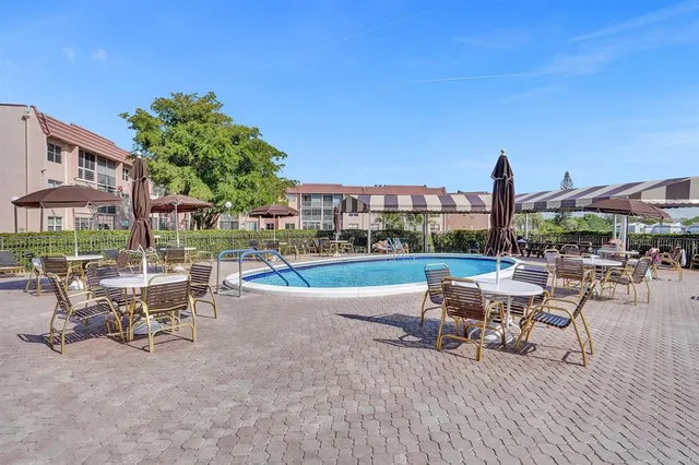 a view of a patio with a table and chairs