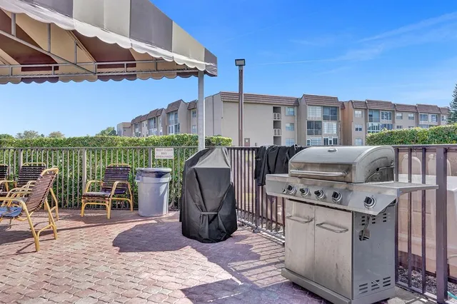 a view of a patio with couches chairs and wooden floor