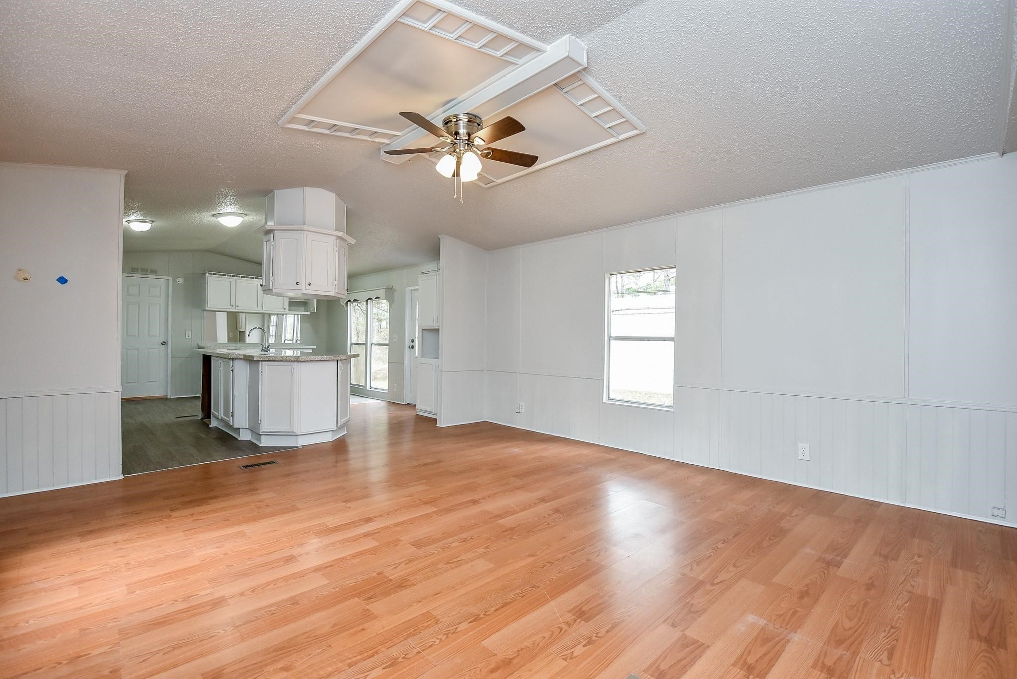 12842 Roy Harris Loop Conroe, TX 77306 - Photo 18 of 36 a view of empty room with wooden floor and ceiling fan