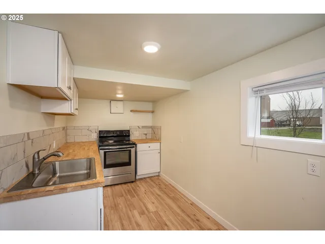 a kitchen with granite countertop a stove and a sink