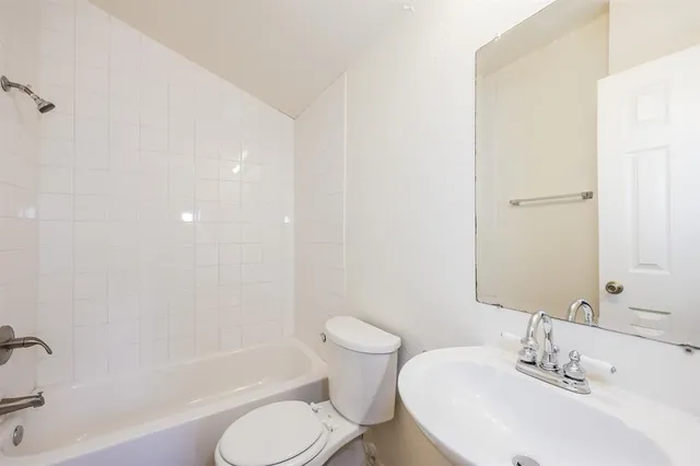 a bathroom with a toilet sink and bathtub