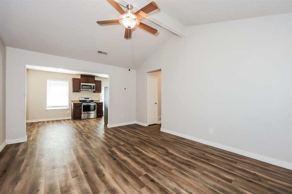 600 Dayton Road Mansfield, TX 76063 - Photo 2 of 18 an empty room with wooden floor ceiling fan and windows