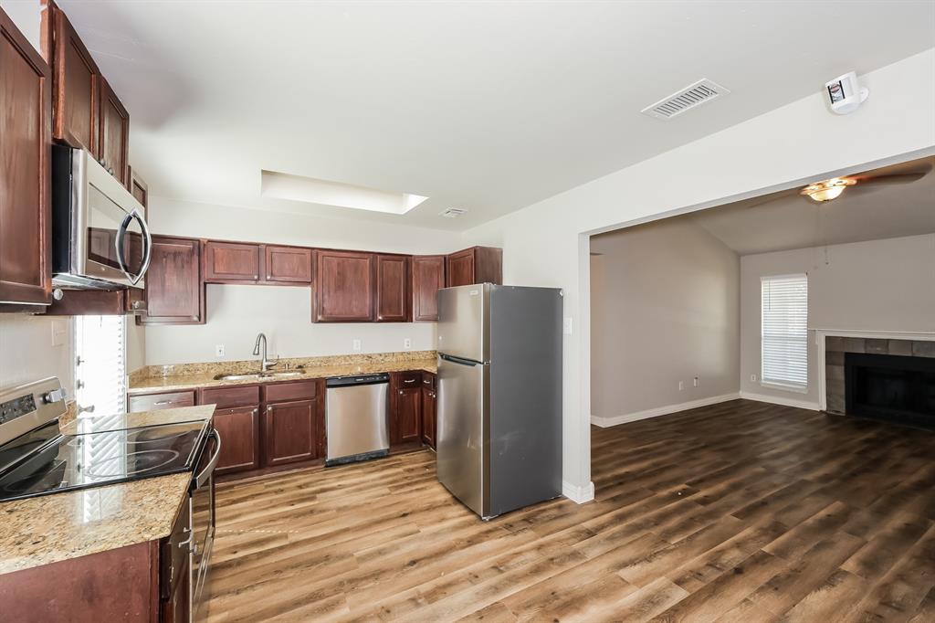 600 Dayton Road Mansfield, TX 76063 - Photo 5 of 18 a kitchen with stainless steel appliances granite countertop a refrigerator and a stove top oven
