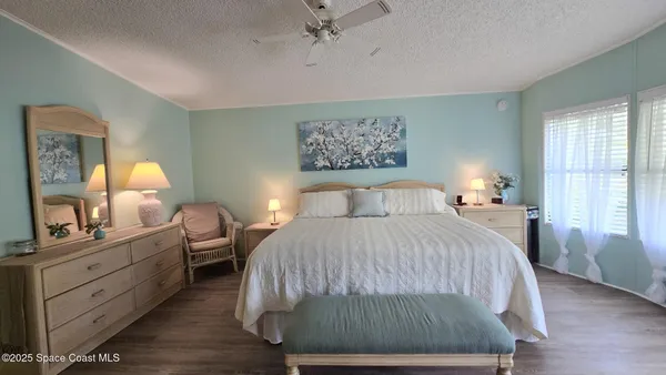 a bedroom with a bed and a night stand