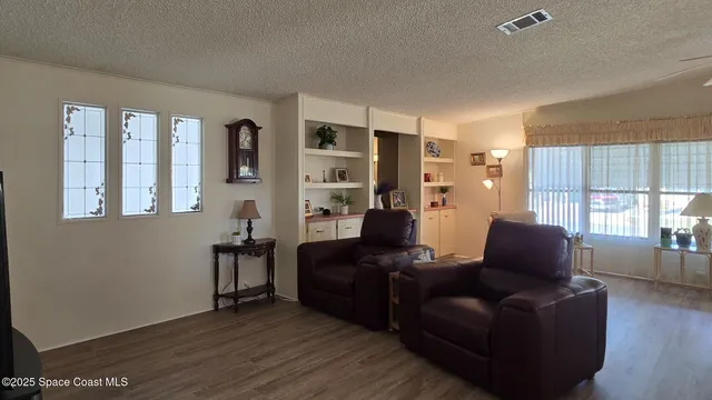 a living room with furniture window and wooden floor