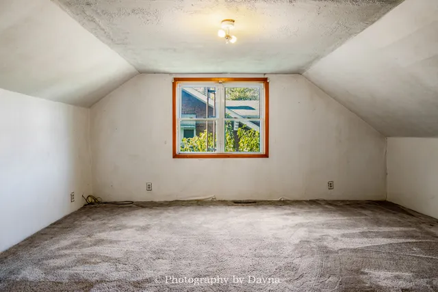 a view of a livingroom with wooden floor and staircase