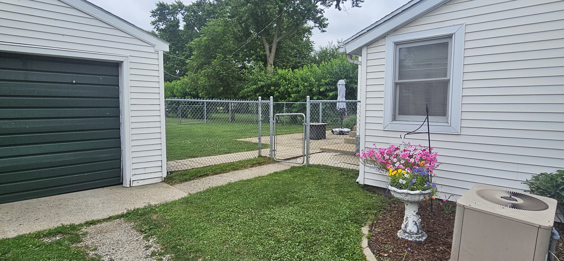 274 West Sheffield Street St. Anne, IL 60964 - Photo 25 of 32 a view of a chair and table in the back yard of the house