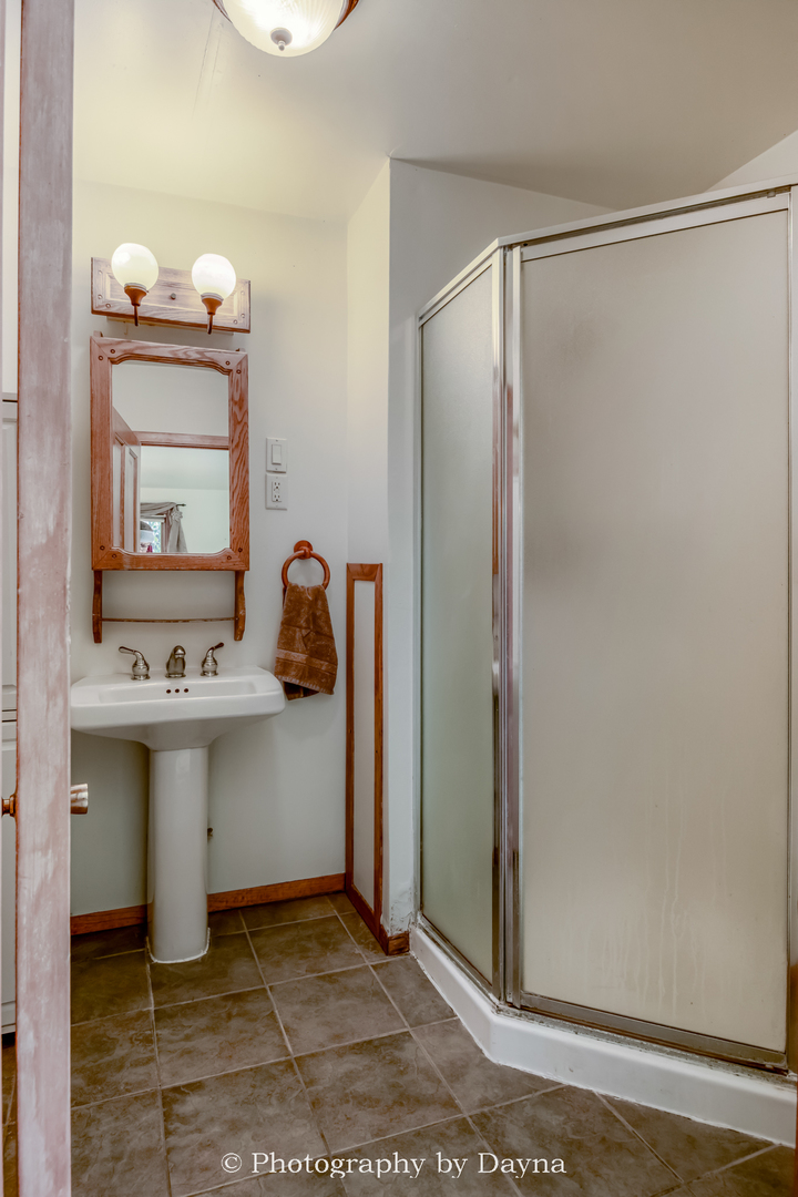 274 West Sheffield Street St. Anne, IL 60964 - Photo 8 of 32 a bathroom with a sink and mirror