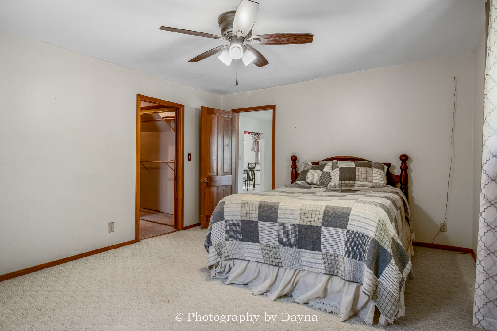 274 West Sheffield Street St. Anne, IL 60964 - Photo 10 of 32 a bedroom with a large bed and a chandelier