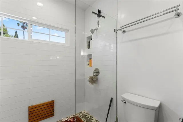 a bathroom with a shower and a toilet