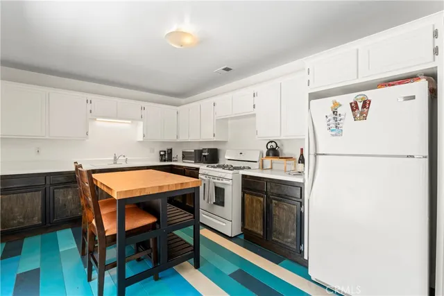 a kitchen with a white stove top oven and refrigerator