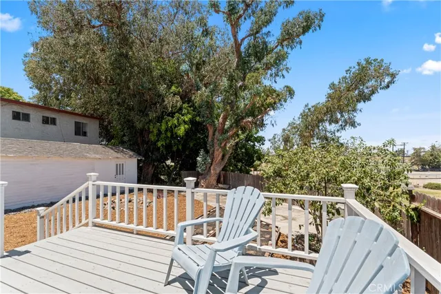 a view of balcony with wooden floor and fence