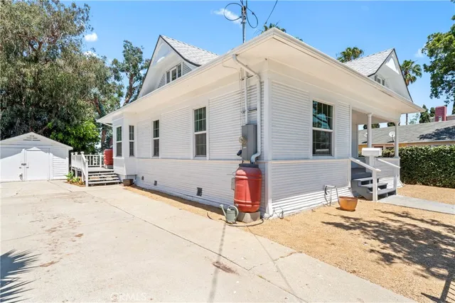 a view of a house with snow on the road