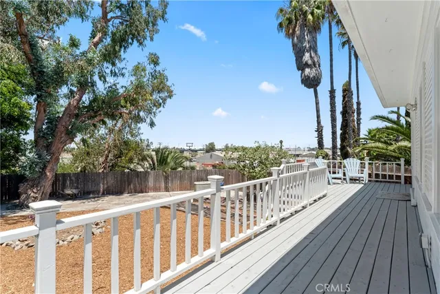 a view of a balcony with wooden floor