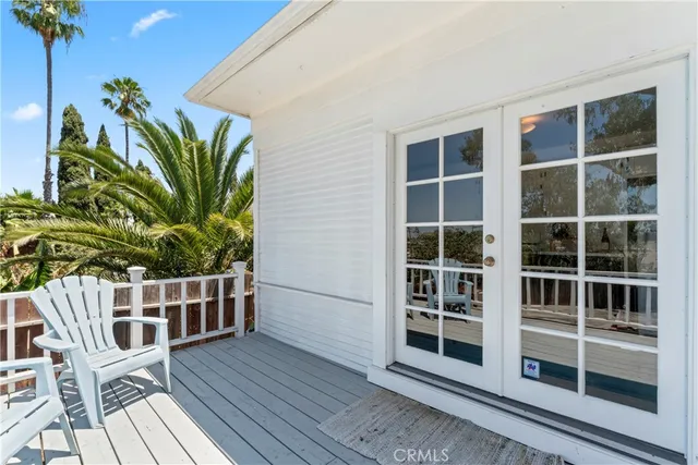 a view of front door deck and potted plants