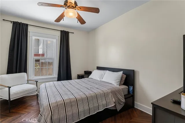 a bedroom with a bed and a chandelier