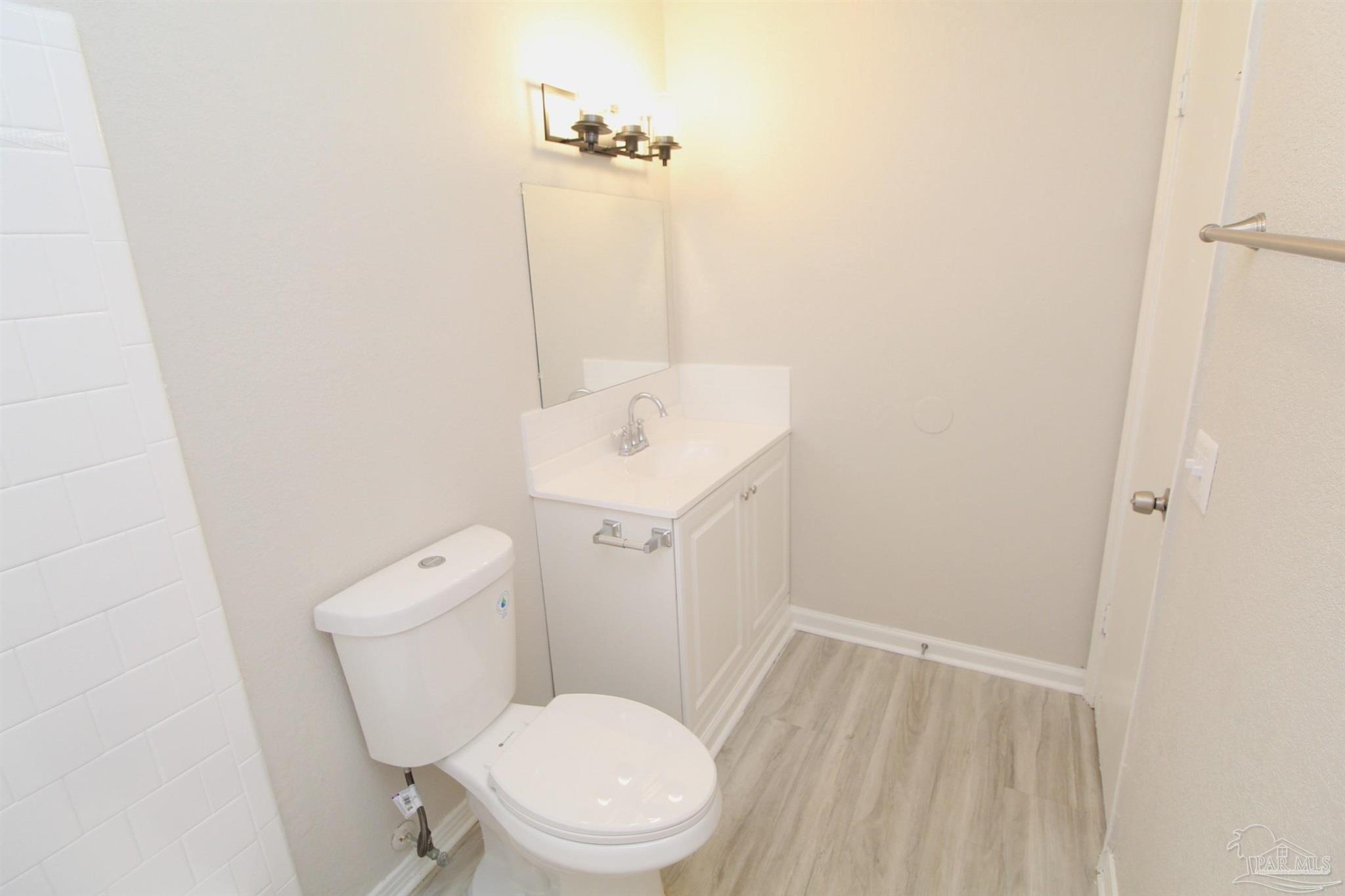 10151 Guidy Lane, Unit B2 Pensacola, FL 32514 - Photo 11 of 11 a white toilet sitting next to a white sink