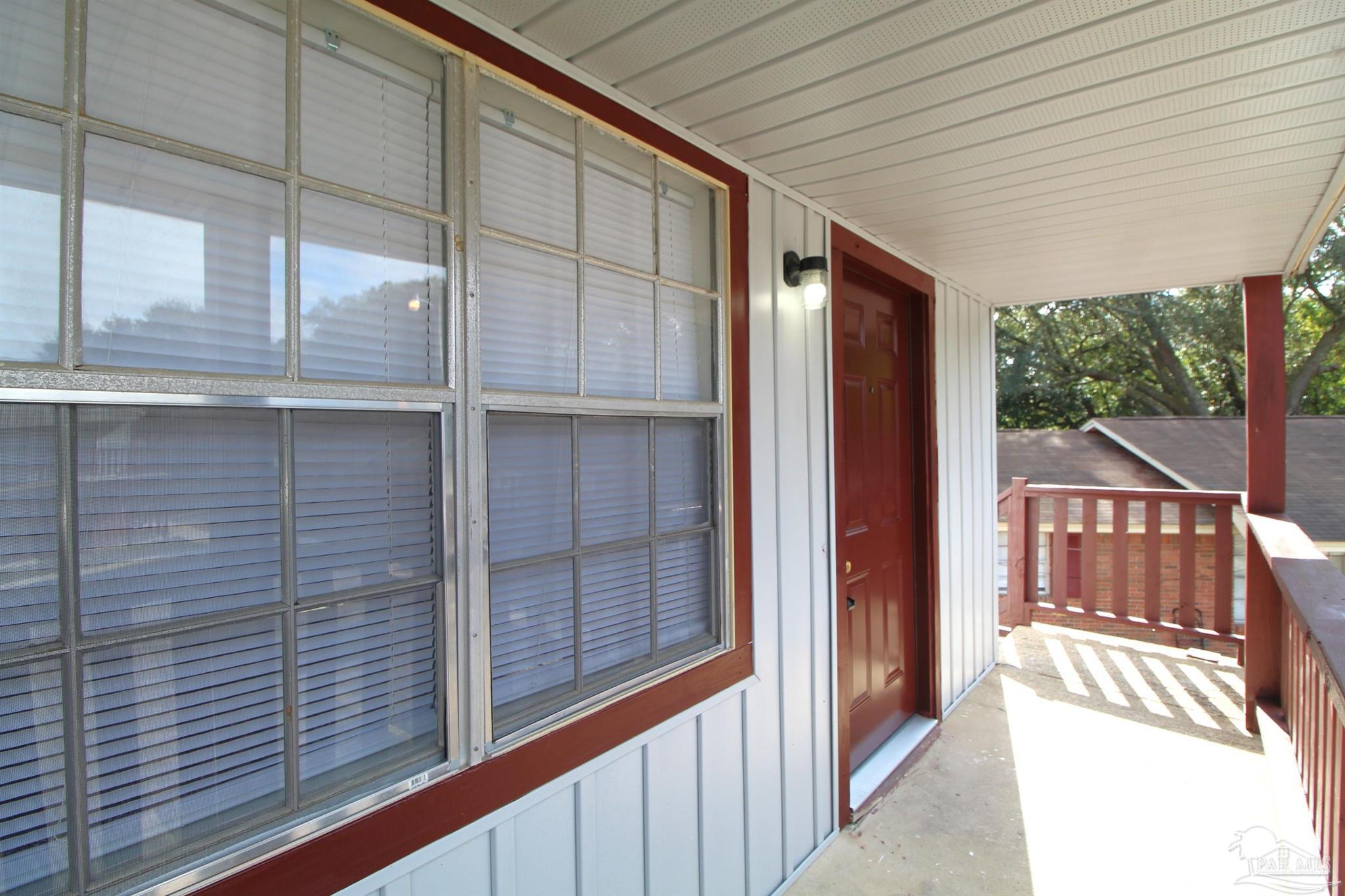 10151 Guidy Lane, Unit B2 Pensacola, FL 32514 - Photo 2 of 11 a view of a porch with wooden floor and outdoor space