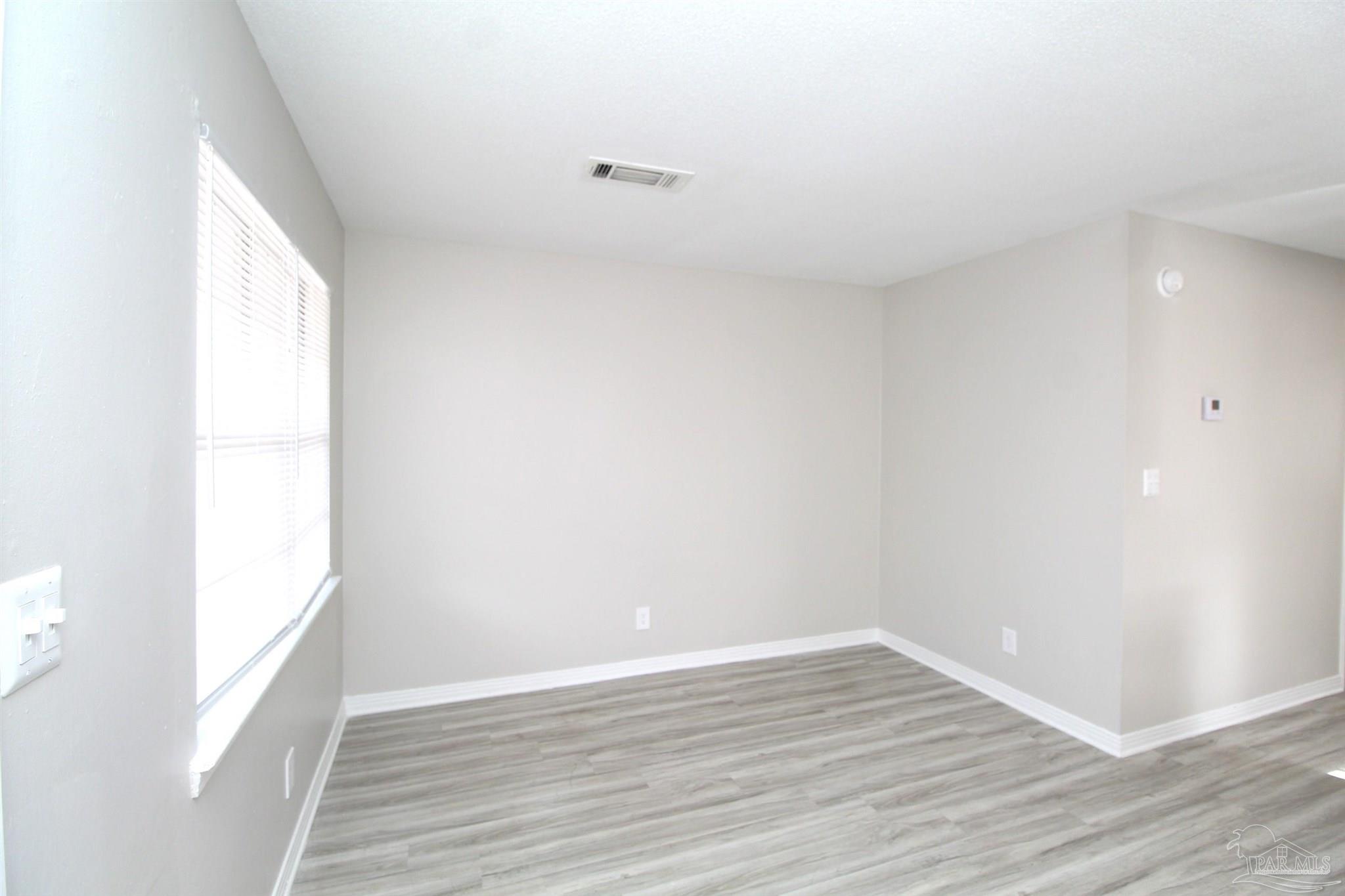 10151 Guidy Lane, Unit B2 Pensacola, FL 32514 - Photo 5 of 11 a view of an empty room and wooden floor