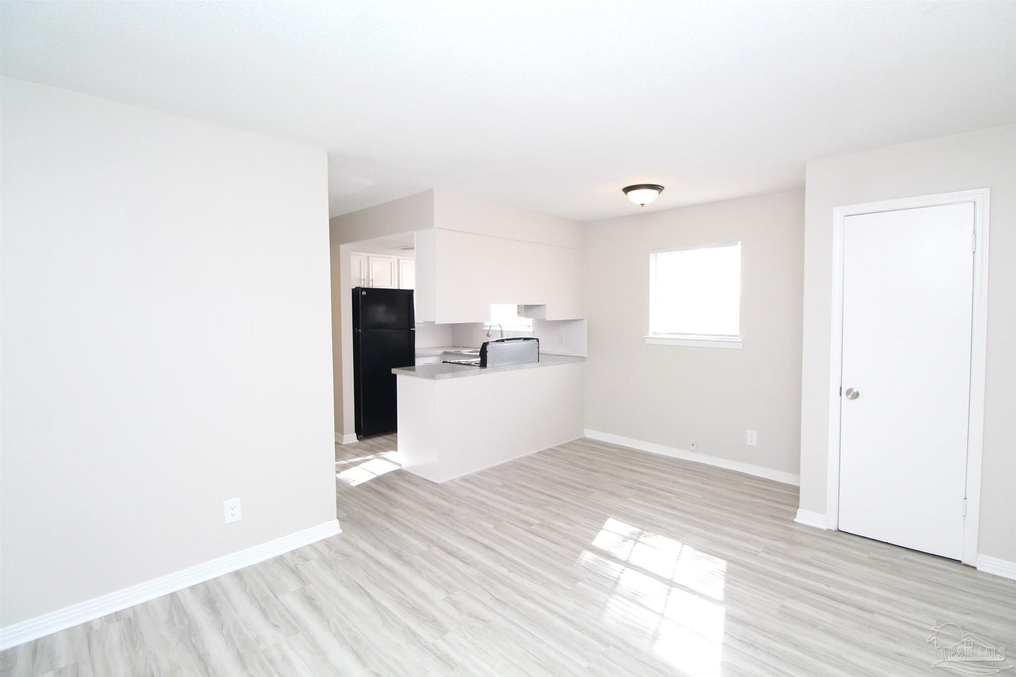 10151 Guidy Lane, Unit B2 Pensacola, FL 32514 - Photo 6 of 11 a view of a kitchen with a sink and a window