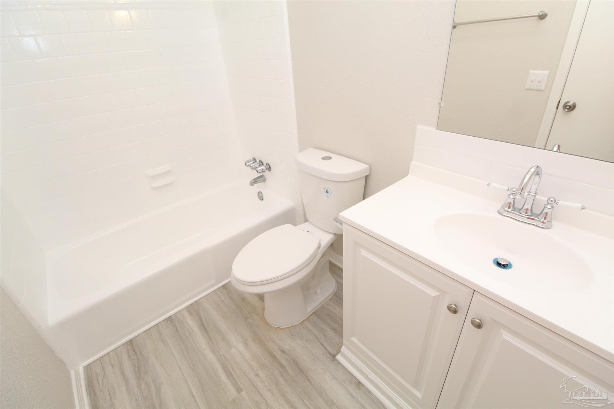 10151 Guidy Lane, Unit B2 Pensacola, FL 32514 - Photo 10 of 11 a white toilet sitting next to a bathroom sink