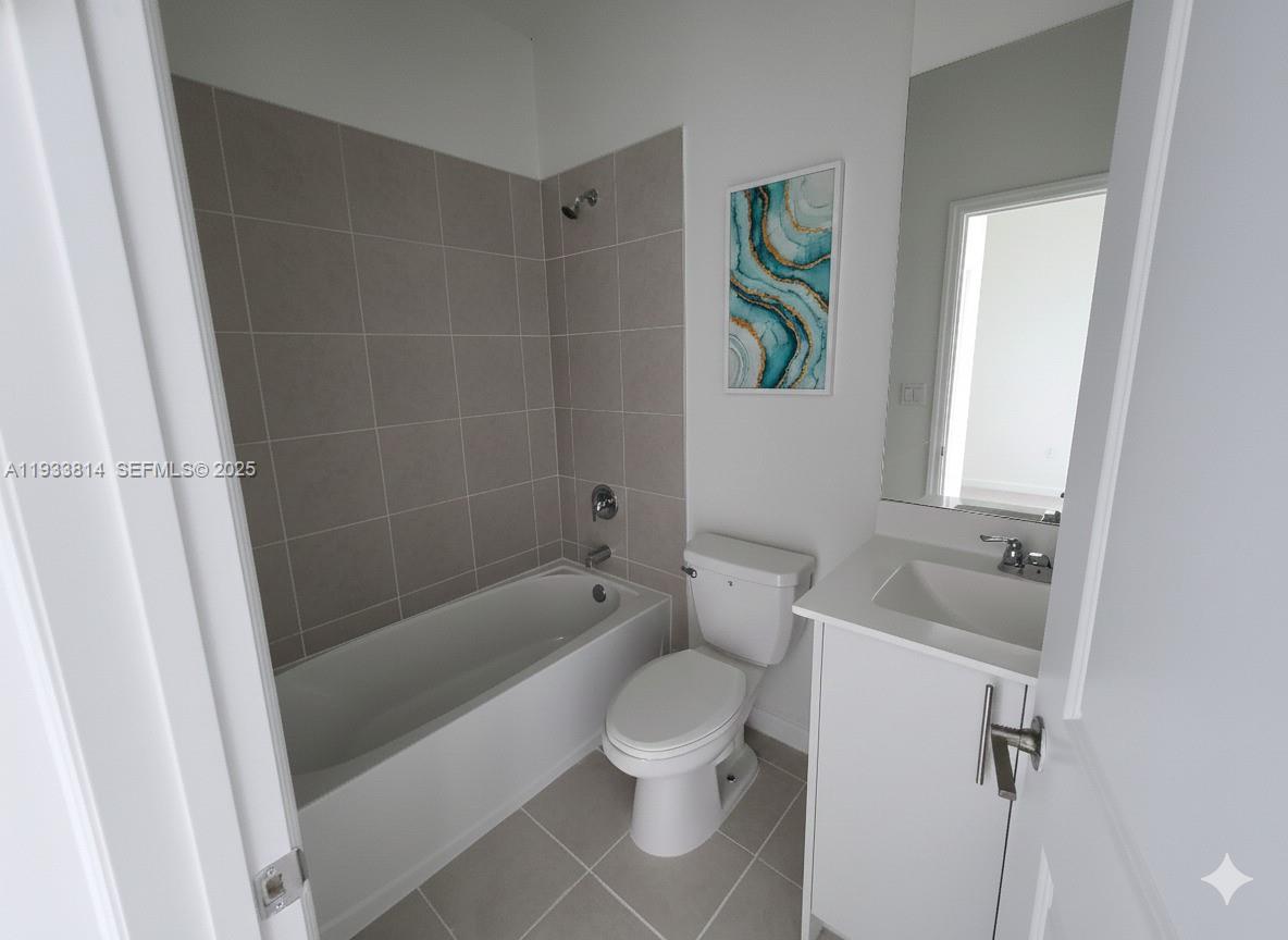 1082 Southeast 2nd Terrace, Unit 57 Homestead, FL 33034 - Photo 12 of 12 a bathroom with a sink toilet and shower