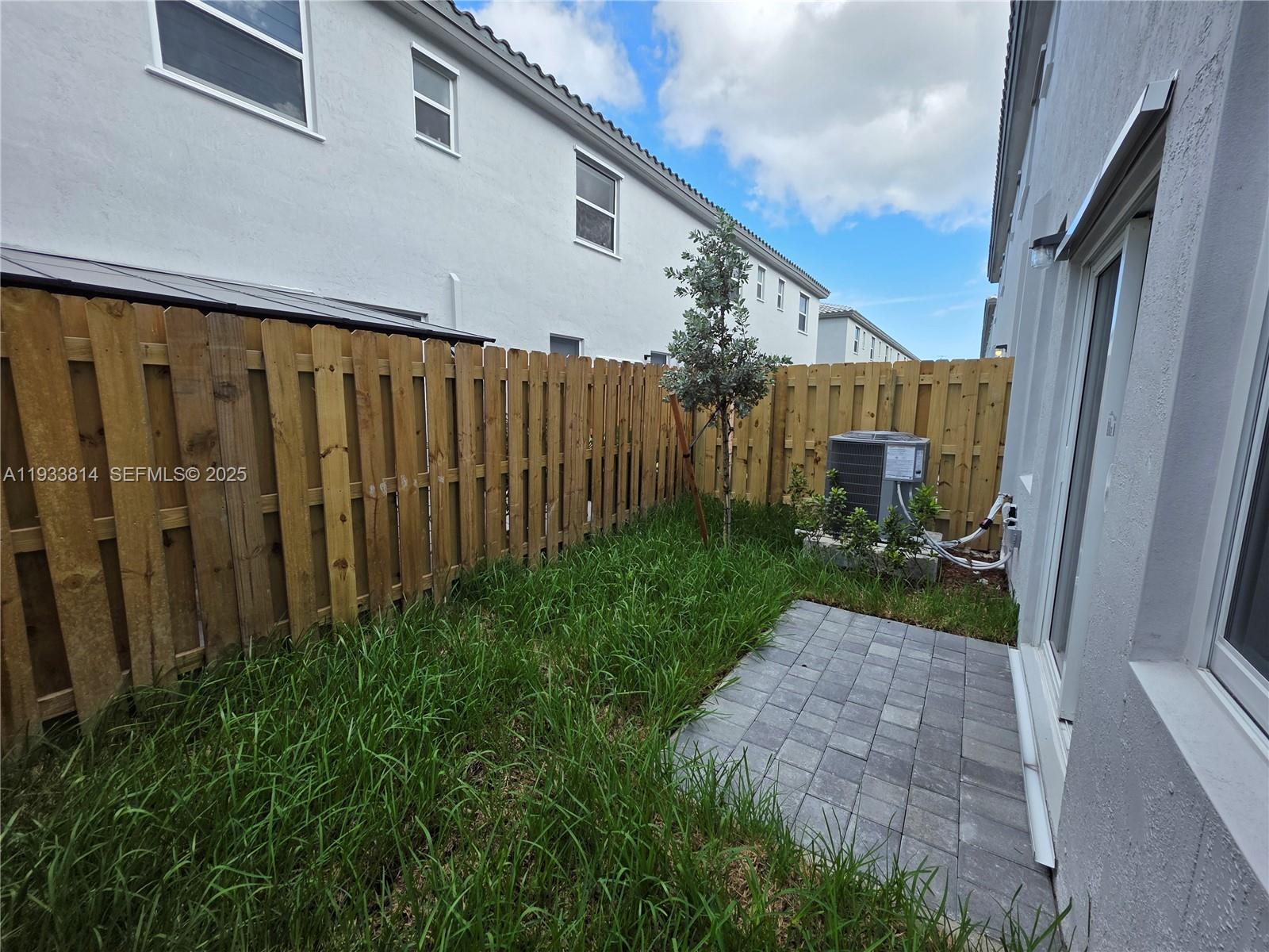 1082 Southeast 2nd Terrace, Unit 57 Homestead, FL 33034 - Photo 2 of 12 a view of a backyard with pathway