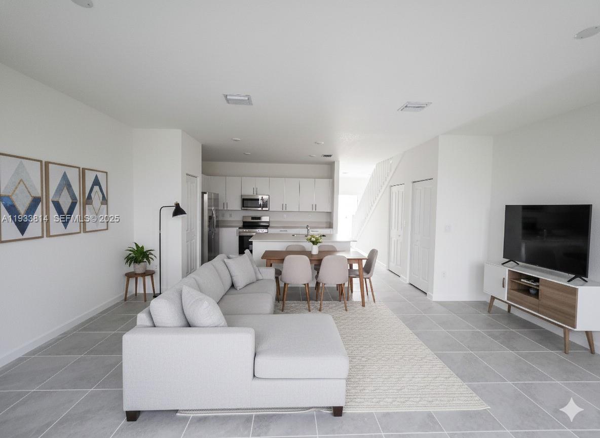 1082 Southeast 2nd Terrace, Unit 57 Homestead, FL 33034 - Photo 8 of 12 a living room with furniture and a flat screen tv