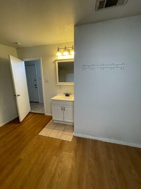 207 West 39th Street, Unit B Austin, TX 78751 - Photo 19 of 20 a view of a room with a sink and wooden floor