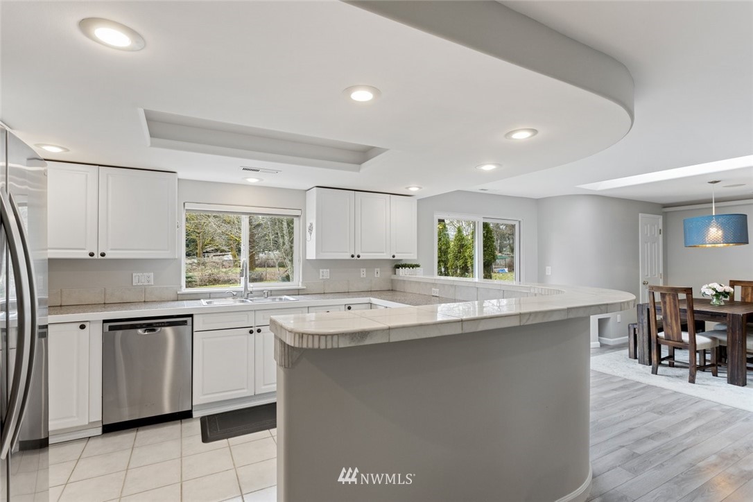 17255 Southeast 142nd Street Renton, WA 98059 - Photo 8 of 26 a kitchen with stainless steel appliances granite countertop a sink and a stove