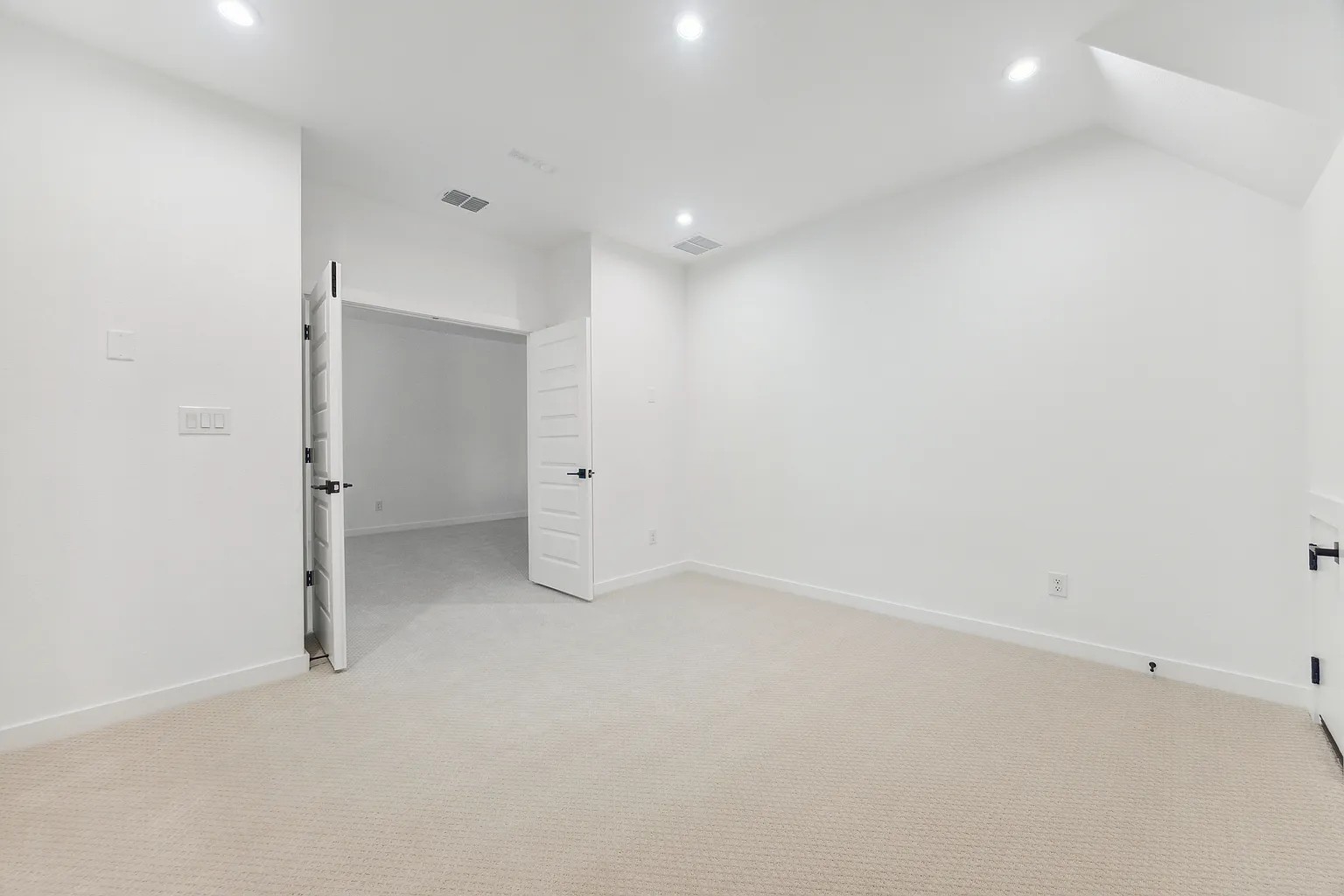 1909 Varese Path Leander, TX 78641 - Photo 28 of 40 A spacious, neutral-toned room with plush carpeting and modern recessed lighting.
