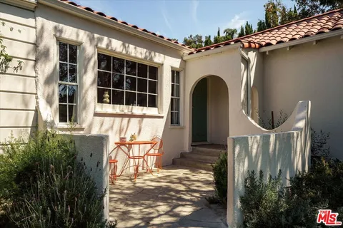 a front view of a house with large windows
