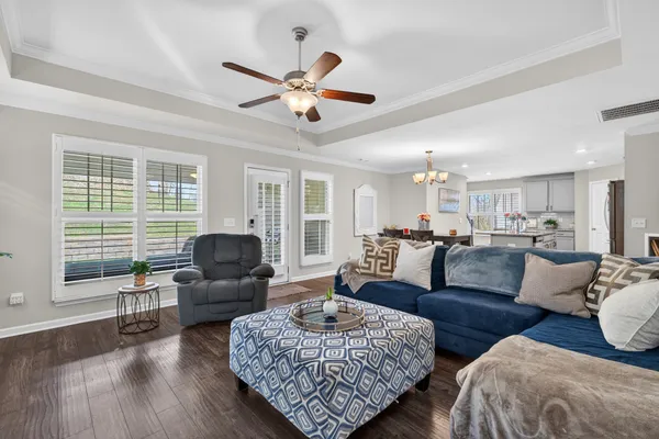 a kitchen with stainless steel appliances granite countertop white cabinets a stove a sink and dishwasher
