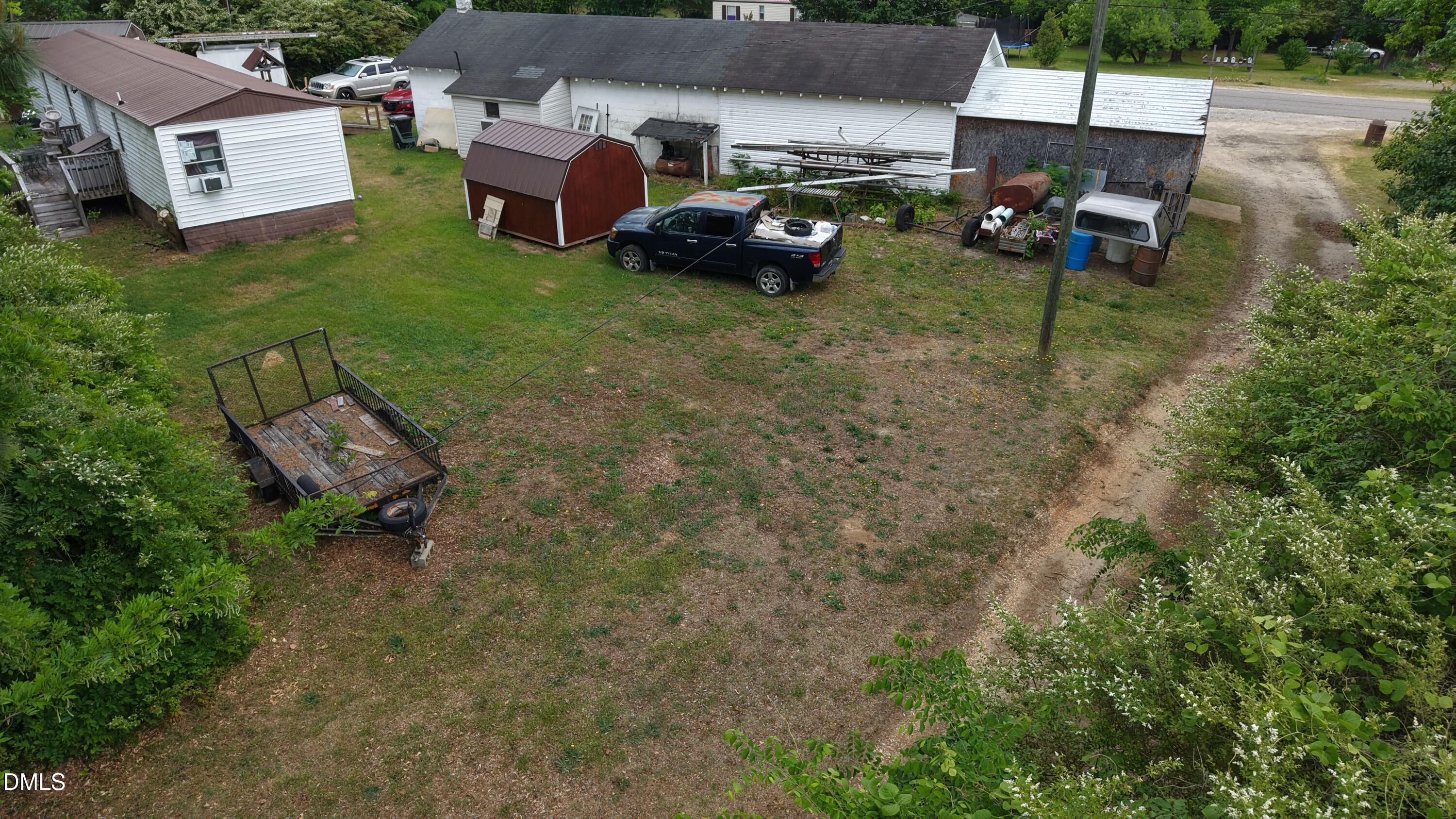 0 Sharpe Road Cameron, NC 28326 - Photo 21 of 22 a backyard of a house with table and chairs