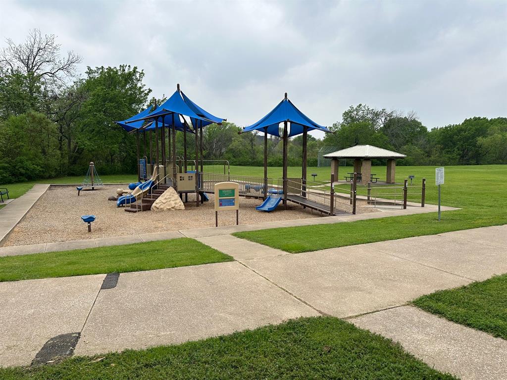 3101 Buckthorn Street Forney, TX 75126 - Photo 34 of 40 Community playground featuring a multi-level play structure with blue shade canopies, slides, and climbing elements